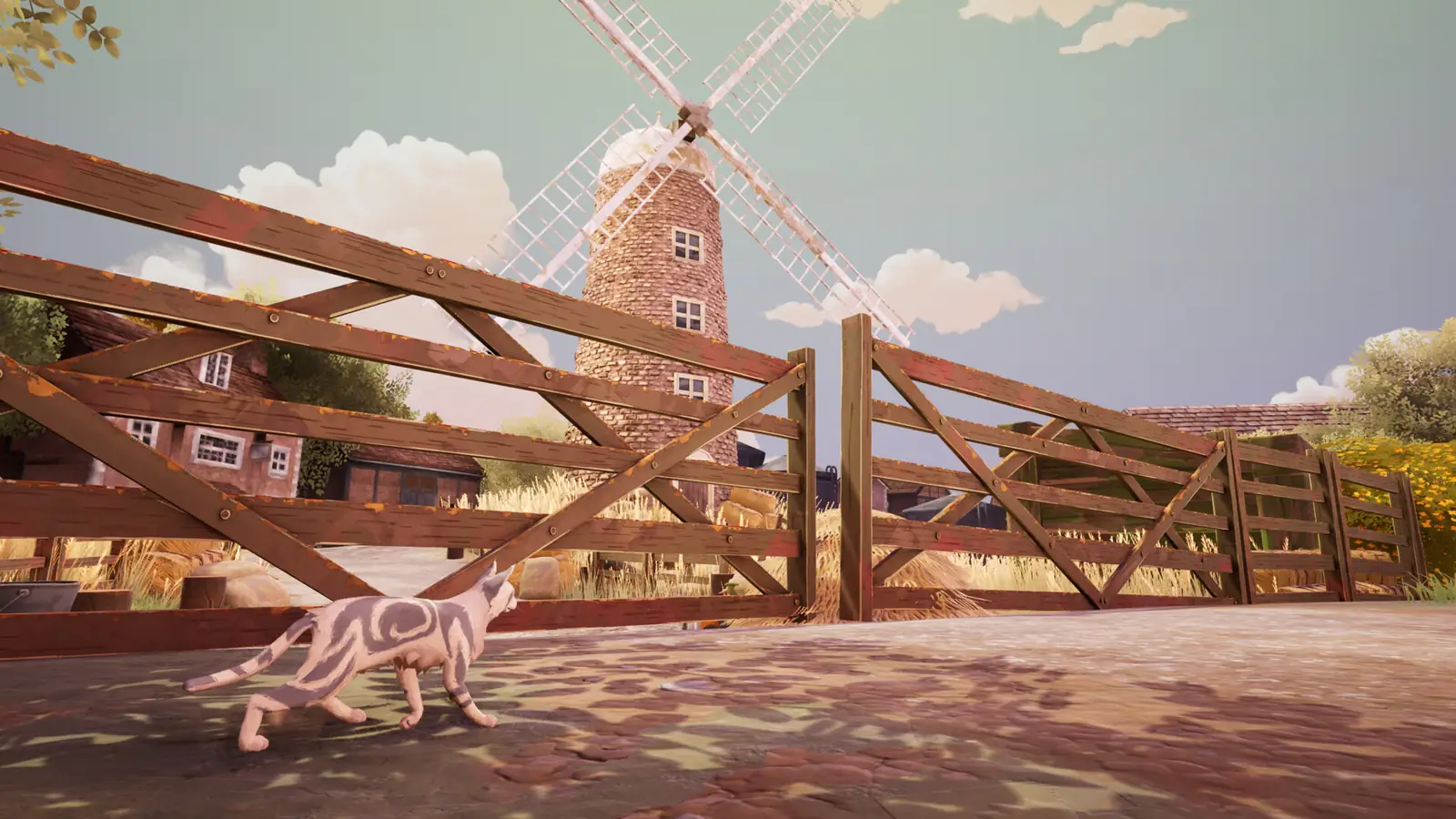 A cat in front of a windmill and a farmhouse